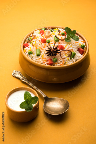Indian Vegetable Pulav or Biryani made using Basmati Rice, served in a ceramic bowl. selective focus