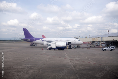 Passenger plane parked at the airport waiting to pick up passengers