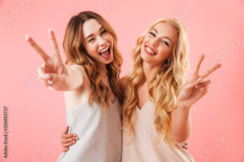 Two happy pretty pretty women in pajamas posing together