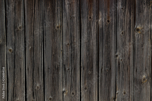 Vertical old natural weathered wooden fence, background texture.