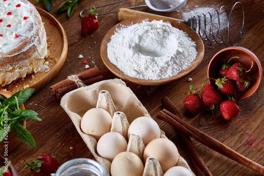 Top view raw ingredients for cooking strawberry pie or cake on wooden table, flat lay. Bakery background. Top view raw ingredients for cooking strawberry pie or cake on wooden table, flat lay. Bakery background.
