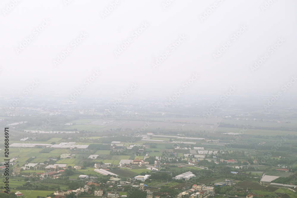 Overlooking farmland and streetscape from Qiwei Mountain in Qishan District, Kaohsiung City, Taiwan. The weather is cloudy and visibility is not good in that day.
