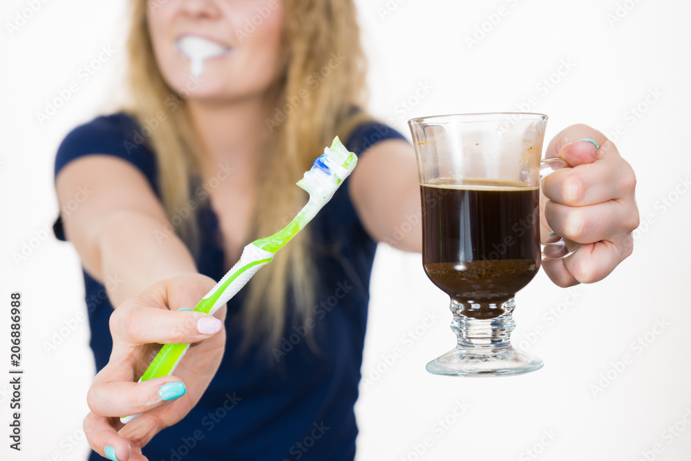 Happy woman holding toothbrush and coffee Happy woman holding toothbrush and coffee