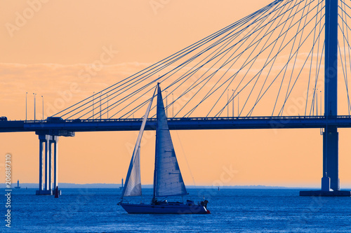 The sailboat sails against ...