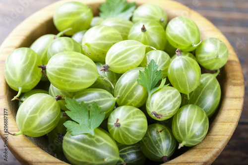 harvest of gooseberry in a wooden plate