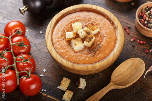 soup gazpacho on a wooden background in a wooden plate.