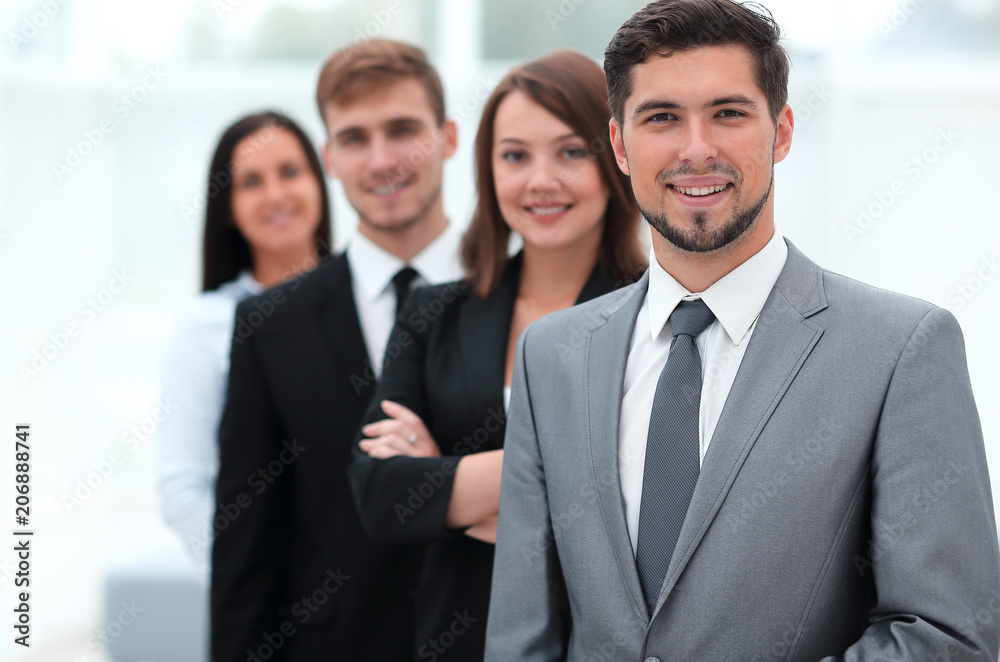 leader and the business team standing one behind the other. leader and the business team standing one behind the other.