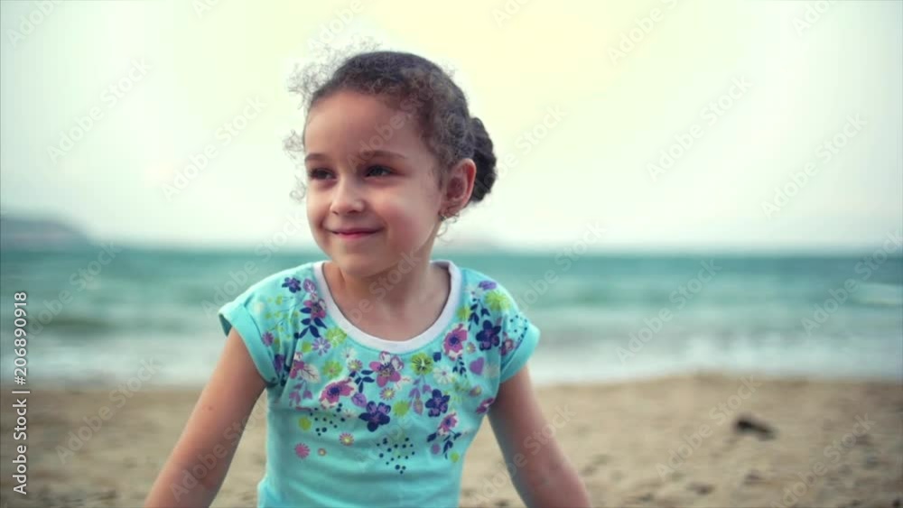 Little girl on the beach, happy little baby playing with sand on the beach. A child, a child, children, emotions. Little girl on the beach, happy little baby playing with sand on the beach. A child, a child, children, emotions.