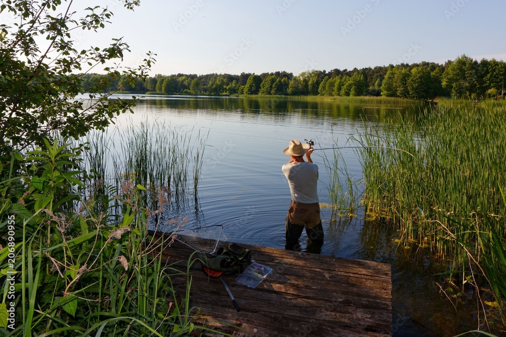 fisherman catching the fish durring sunny day