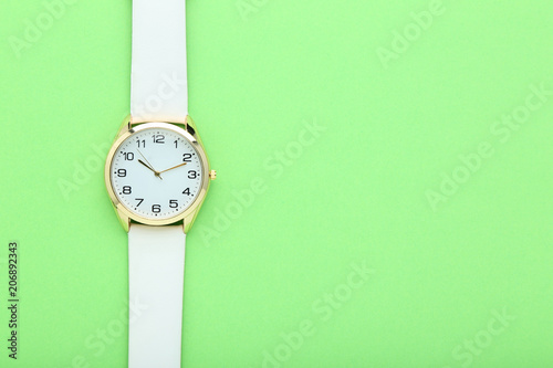 Wrist watch on green background