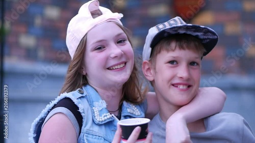 Happy sister outdoors hugging brother. Happy brother and sister. Happy family teenager.