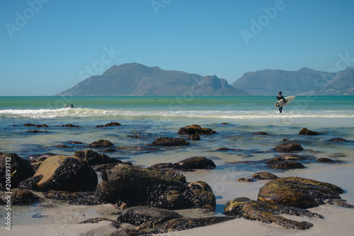 Surfers at Kommetjie Beach in Cape Town, South Africa photo