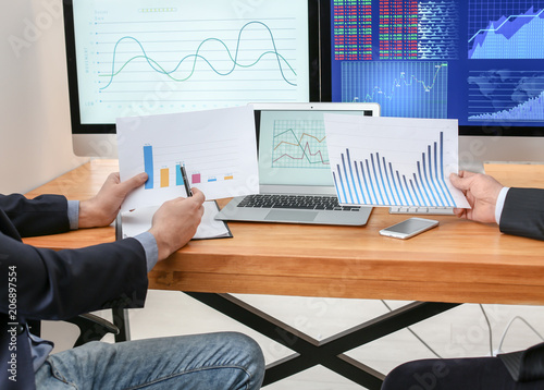 Male brokers working in off...