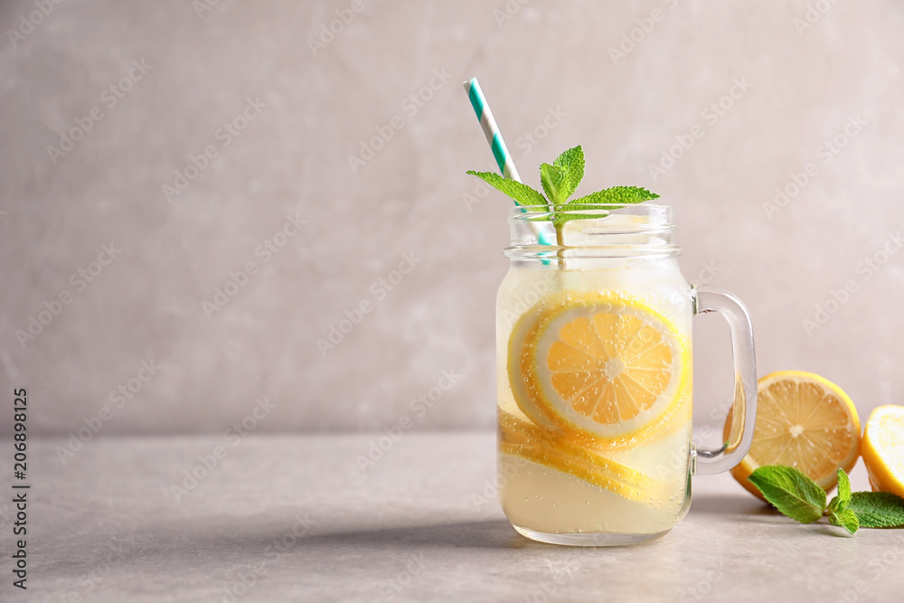 Fototapeta premium Refreshing natural lemonade in mason jar on table