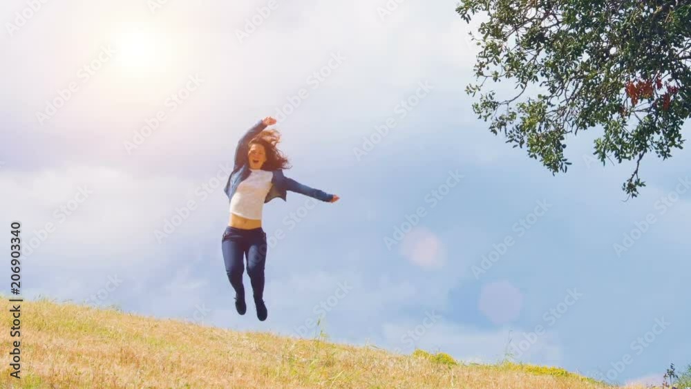 Happy young woman enjoying wonderful life, jumping at field, excited person Happy young woman enjoying wonderful life, jumping at field, excited person