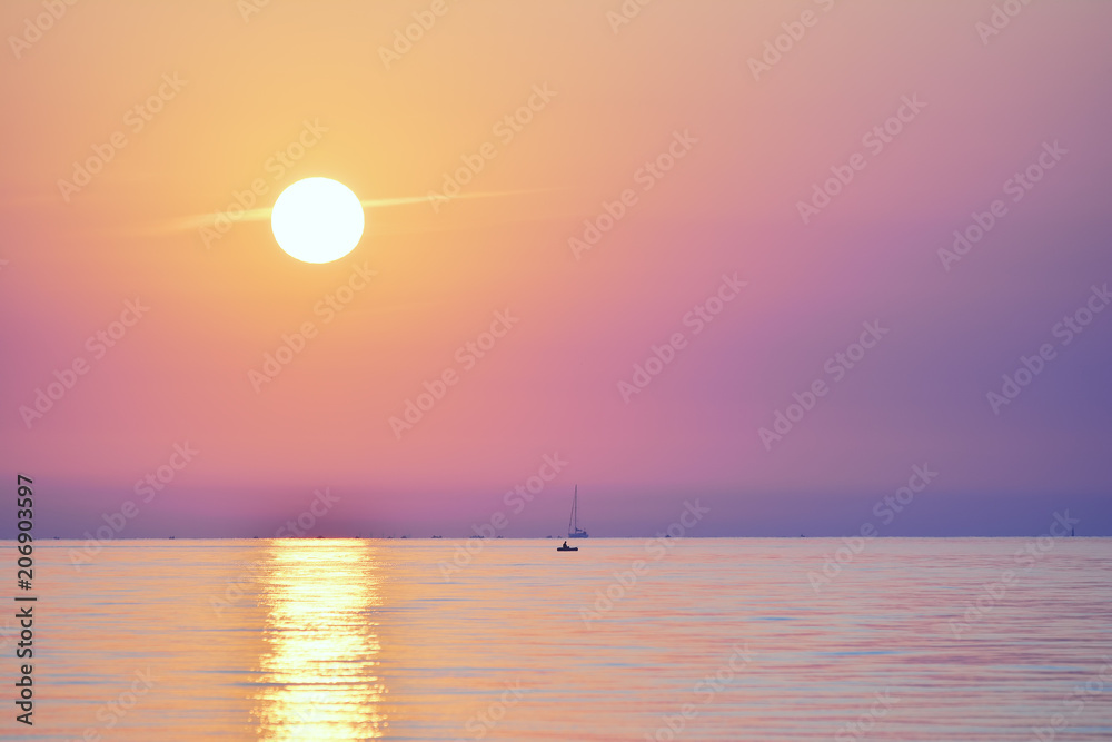 Sunrise at the sea. Seascape of the morning dawn. Early morning on the beach.