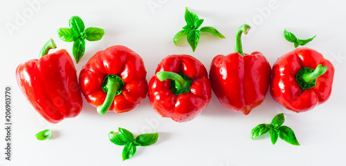 banner group of red ripe organic bell pepper and fresh basil leaves isolated on white
