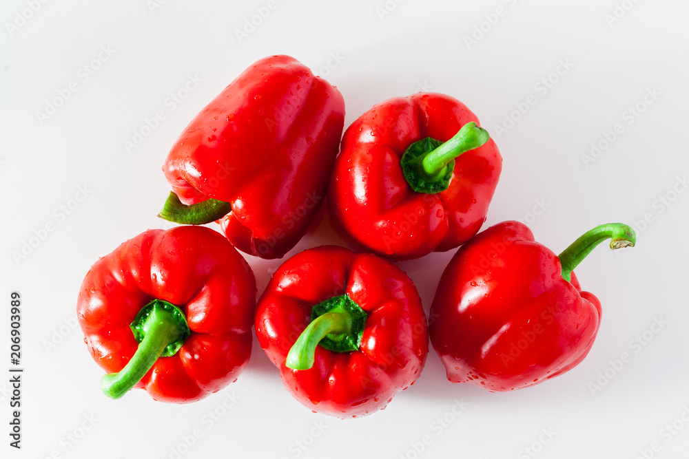 group of red ripe organic bell pepper and fresh basil leaves isolated on white