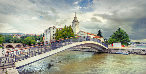 Bridge over canal and view of church tower in Crikvenica. Croatia