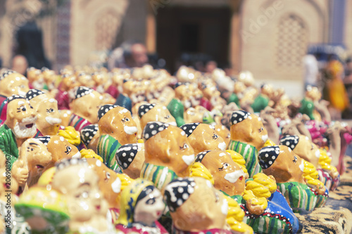 BUKHARA, UZBEKISTAN - MAY 25, 2018: Silk and Spices Festival 2018. Souvenirs shop in Bukhara, Uzbekistan. Gift Sets handmade. Miniature handmade Uzbek ceramic souvenir.