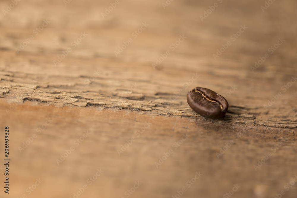 A coffee bean on a wood table A coffee bean on a wood table