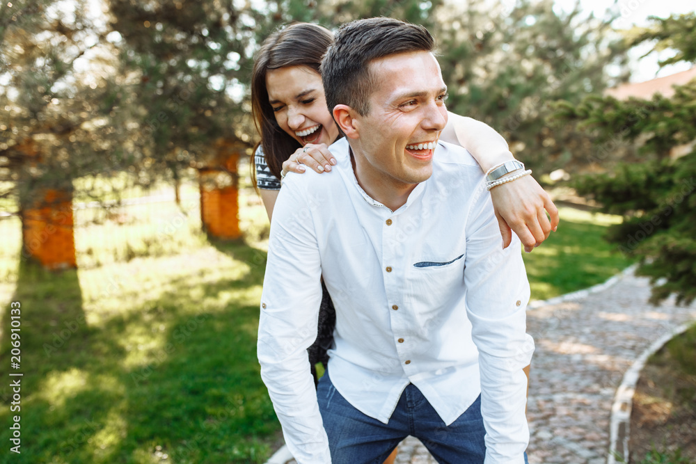 young, happy, loving couple, frolic and have fun in the Park, and enjoy each other, advertising, and inserting text young, happy, loving couple, frolic and have fun in the Park, and enjoy each other, advertising, and inserting text