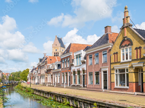 Canal and tower of church in old town of Bolsward, Friesland, Netherlands