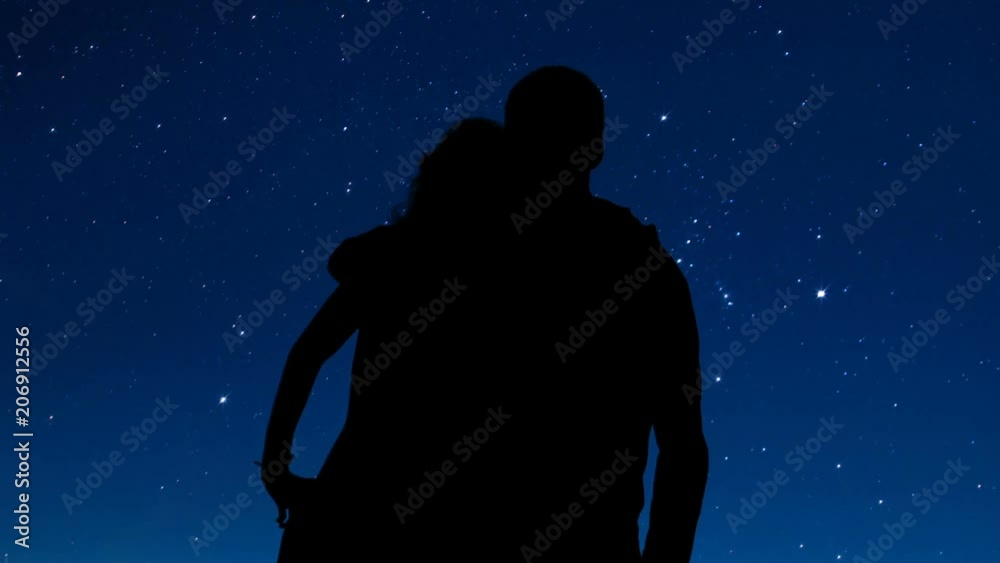 Loving couple shadow hugging and looking at stars in night sky, romantic date Loving couple shadow hugging and looking at stars in night sky, romantic date