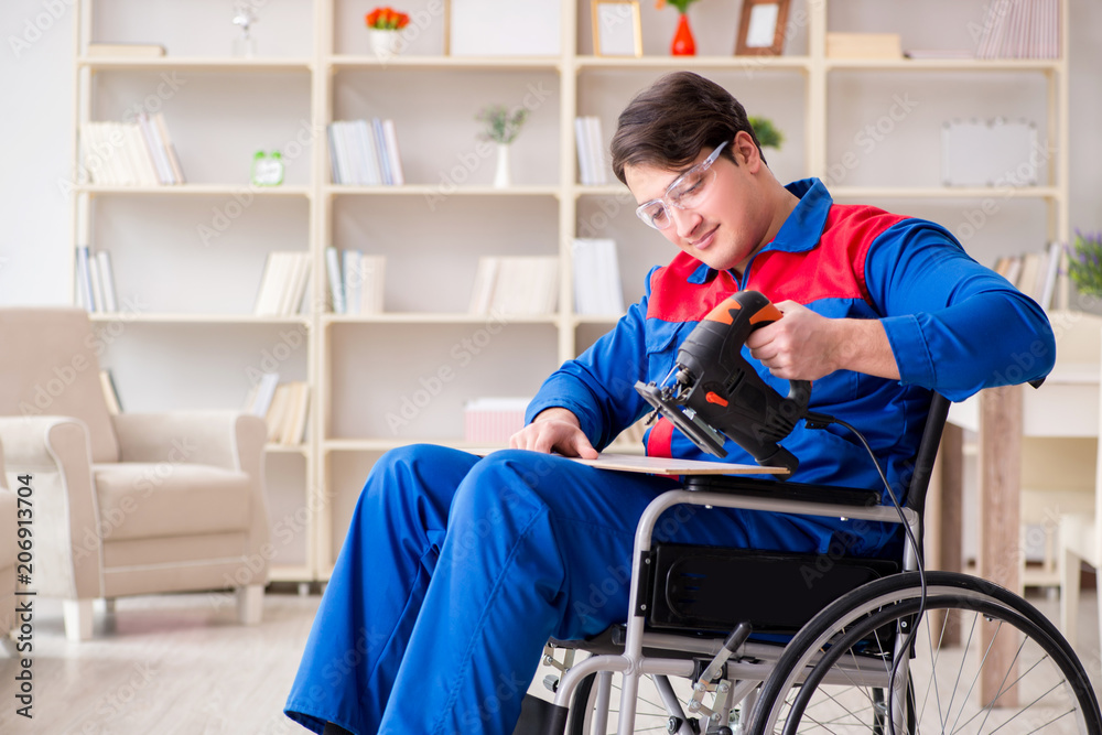 Disabled man working with handsaw at home Disabled man working with handsaw at home