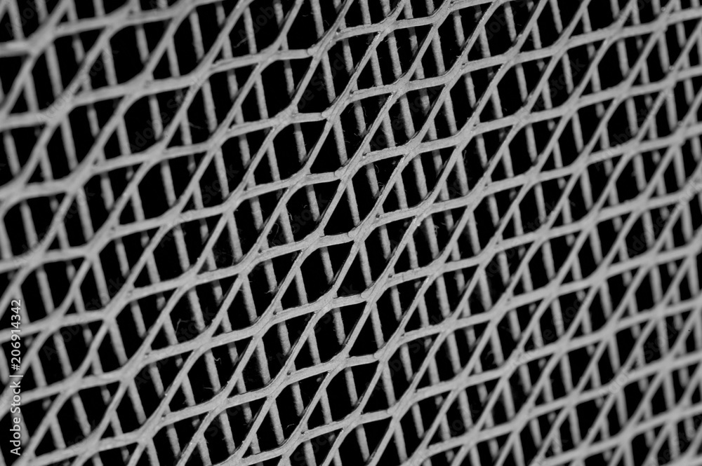 Metal lattice texture close-up. The image is inclined. Rhombus.