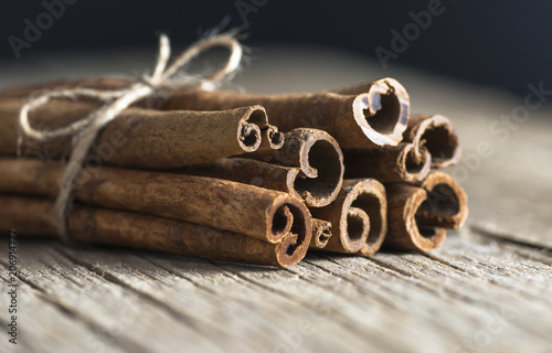 Close up cinnamon healthy spice on wooden background photo