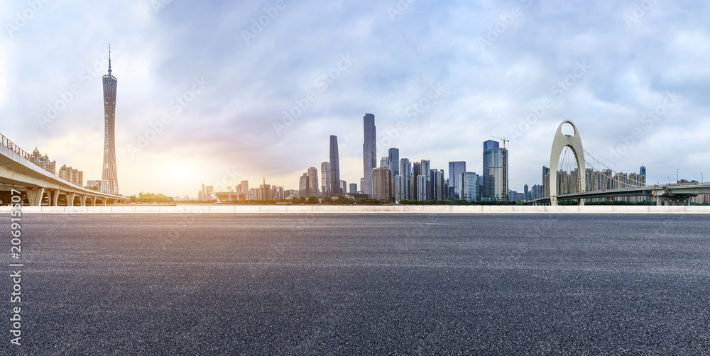 asphalt road and modern city skyline in Guangzhou at sunset,China