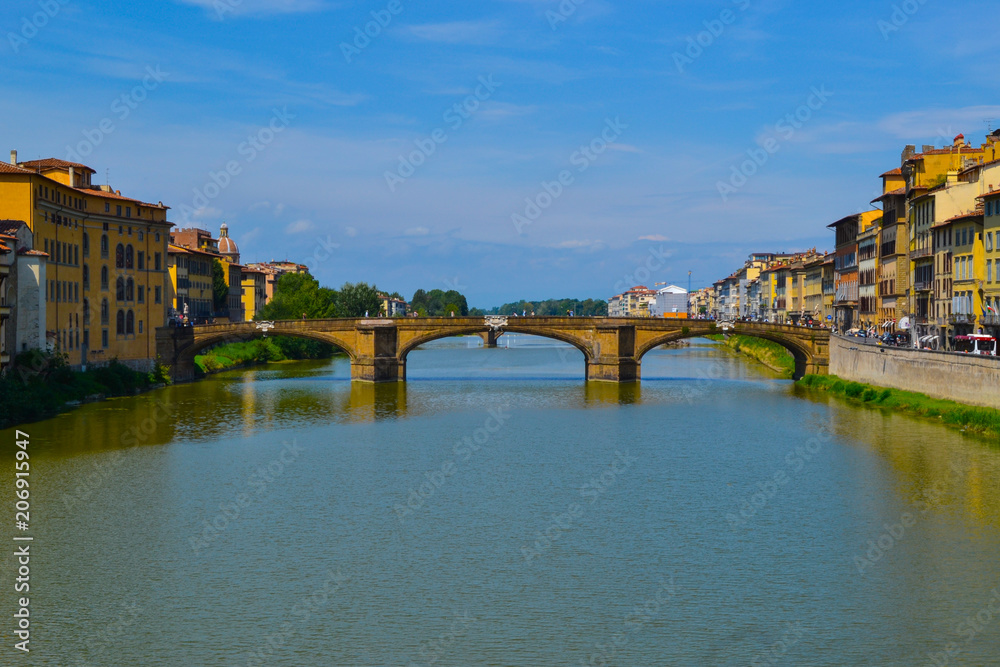 Arno river with Ponte Santa Trinita (Holy Trinity Bridge) at the background, in Florence, Italy.