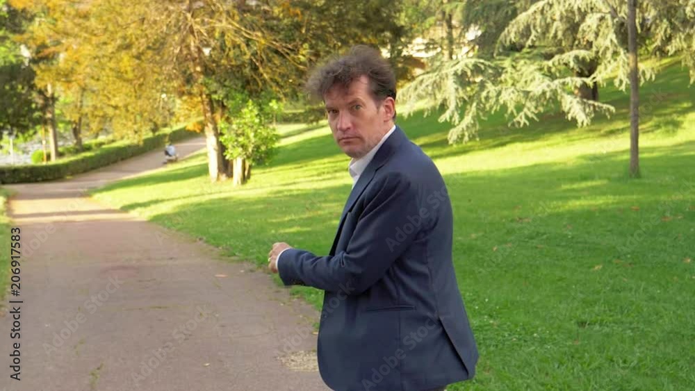 Man in park walking warning to stop concept slow motion closeup