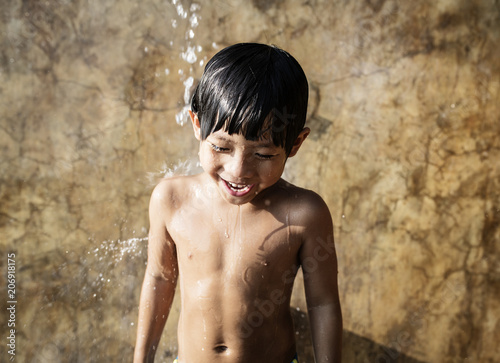 A little boy taking a shower