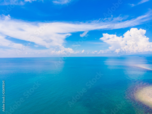 Beautiful aerial view of beach and sea with many tree and white cloud on blue sky in koh samui island