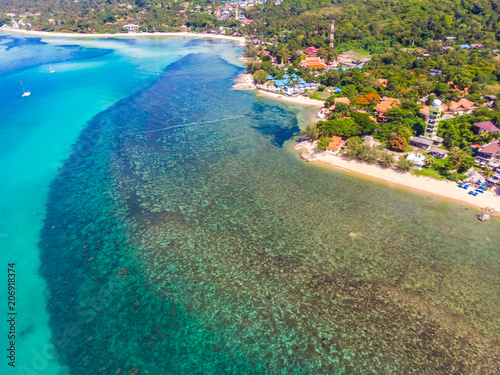 Beautiful aerial view of beach and sea with many tree and white cloud on blue sky in koh samui island