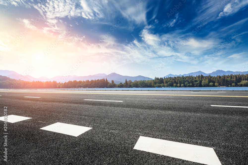 Asphalt road and hills with sky clouds landscape at sunset