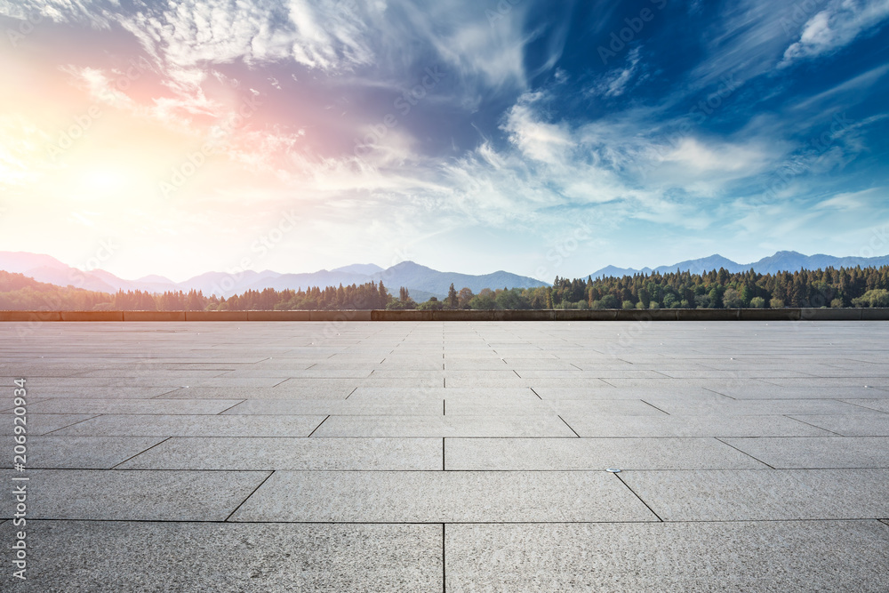 Empty square floor and hills landscape at sunset
