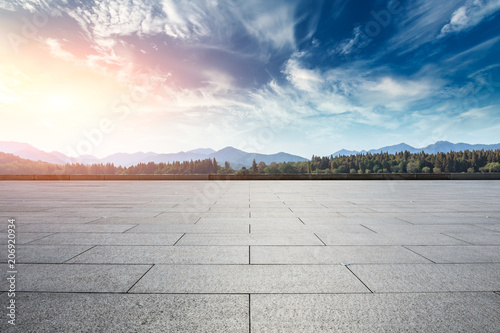 Empty square floor and hills landscape at sunset © ABCDstock
