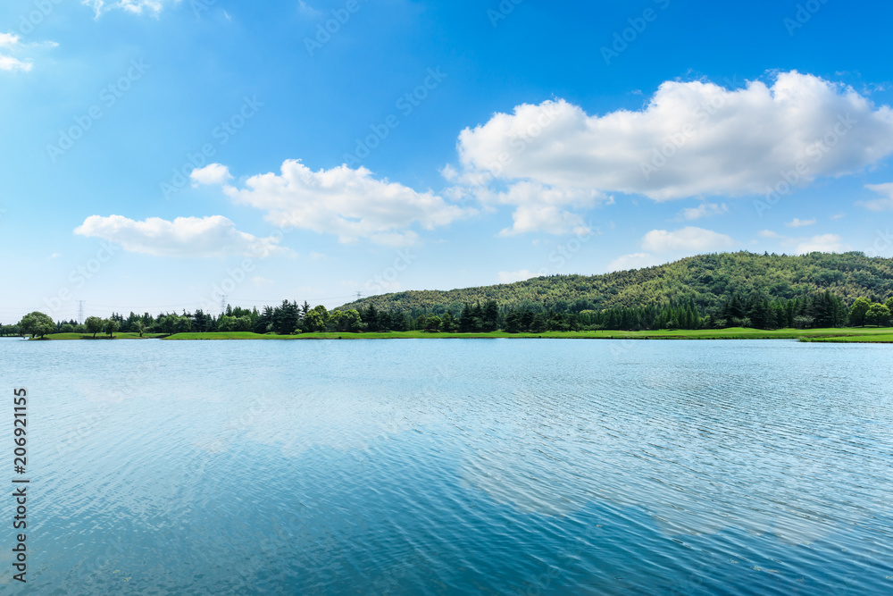 Clean lake and green hills under the blue sky Clean lake and green hills under the blue sky