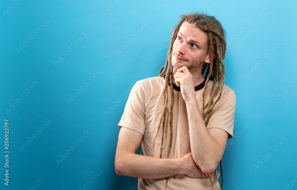 Young man in a thoughtful pose on a solid background Young man in a thoughtful pose on a solid background