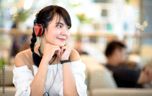 Asian girl listen to music in internet cafe,select focus.
