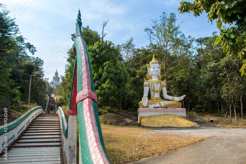 Wat Phra Bat Phu Phan, Khon Kaen DEC 09 2017:  Steep steps  (luang-phor Phu Phan Kham, buddha sculpture) a view from Ubolratana dam photo