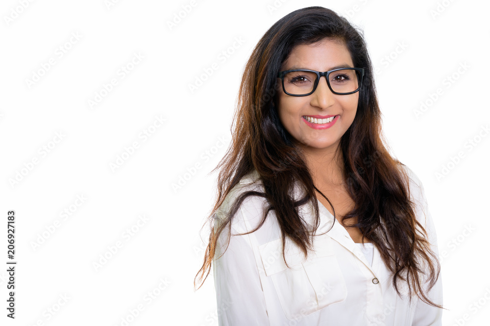 Studio shot of young happy Persian woman smiling with eyeglasses Studio shot of young happy Persian woman smiling with eyeglasses