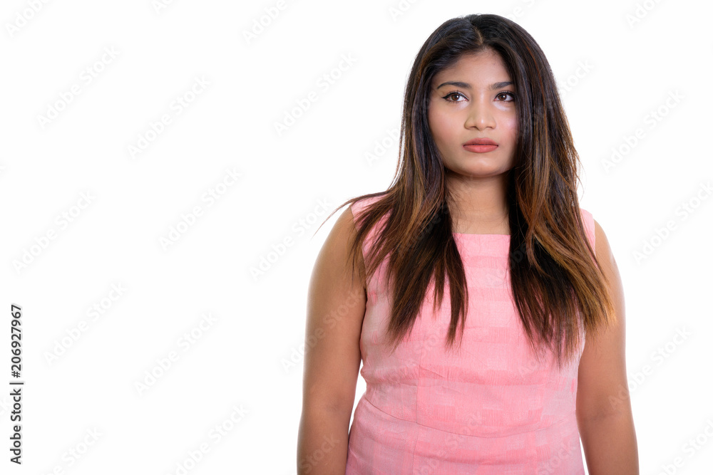 Studio shot of young fat Persian teenage girl thinking isolated Studio shot of young fat Persian teenage girl thinking isolated