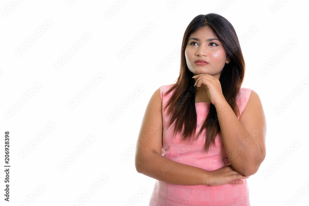 Studio shot of young fat Persian teenage girl thinking isolated Studio shot of young fat Persian teenage girl thinking isolated