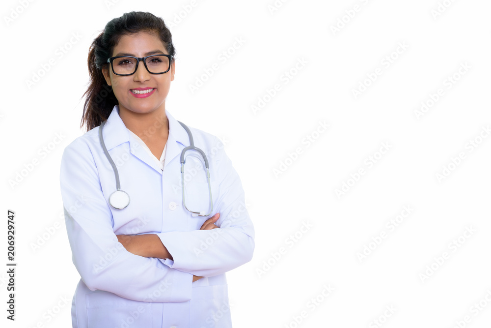 Fototapeta premium Studio shot of young happy Persian woman doctor smiling while we