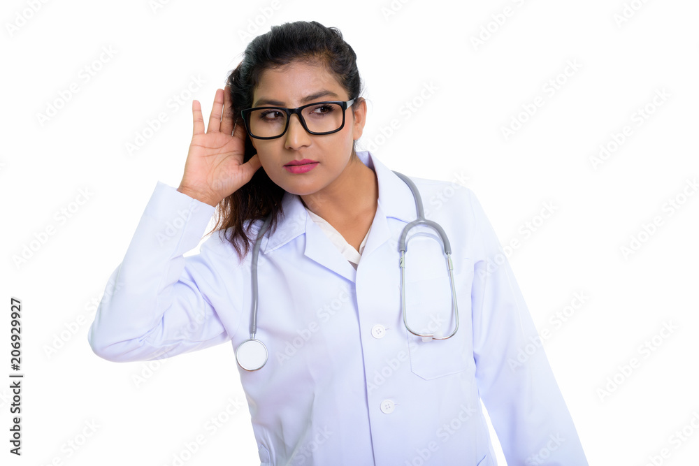 Studio shot of young beautiful Persian woman doctor listening an Studio shot of young beautiful Persian woman doctor listening an