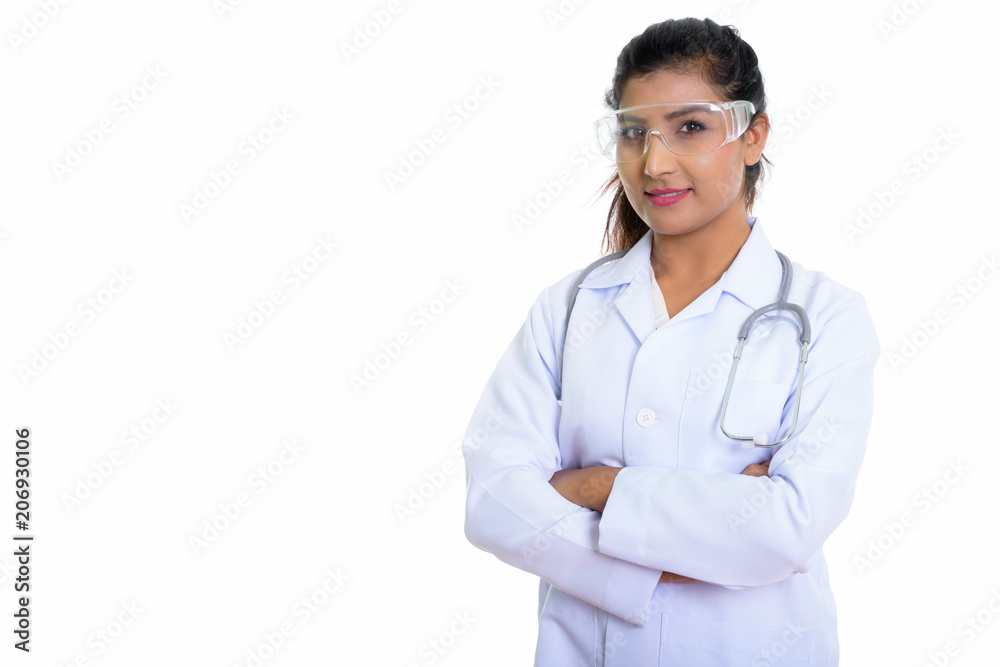 Studio shot of young beautiful Persian woman doctor wearing prot Studio shot of young beautiful Persian woman doctor wearing prot